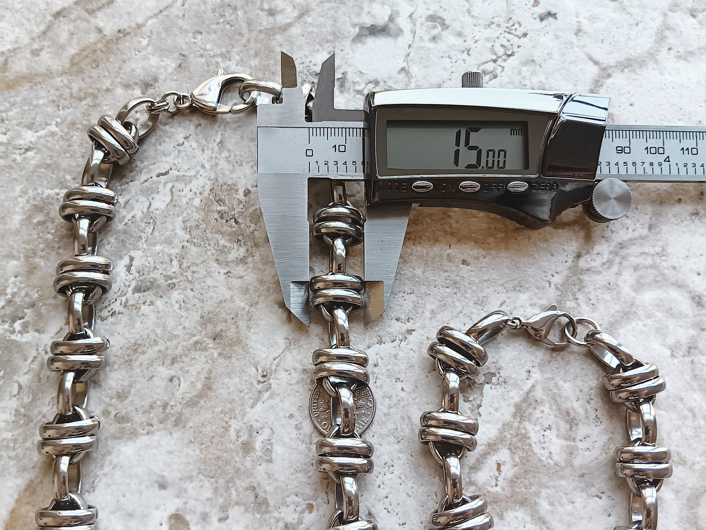 Double Ellipse Chain Necklace and Bracelet against a calibre to show width of necklace and bracelet