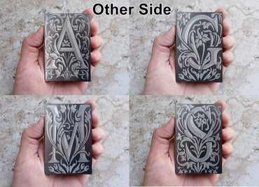 Top view of the different floral monogram letters engraved examples on the other side of the Stainless Steel Case.